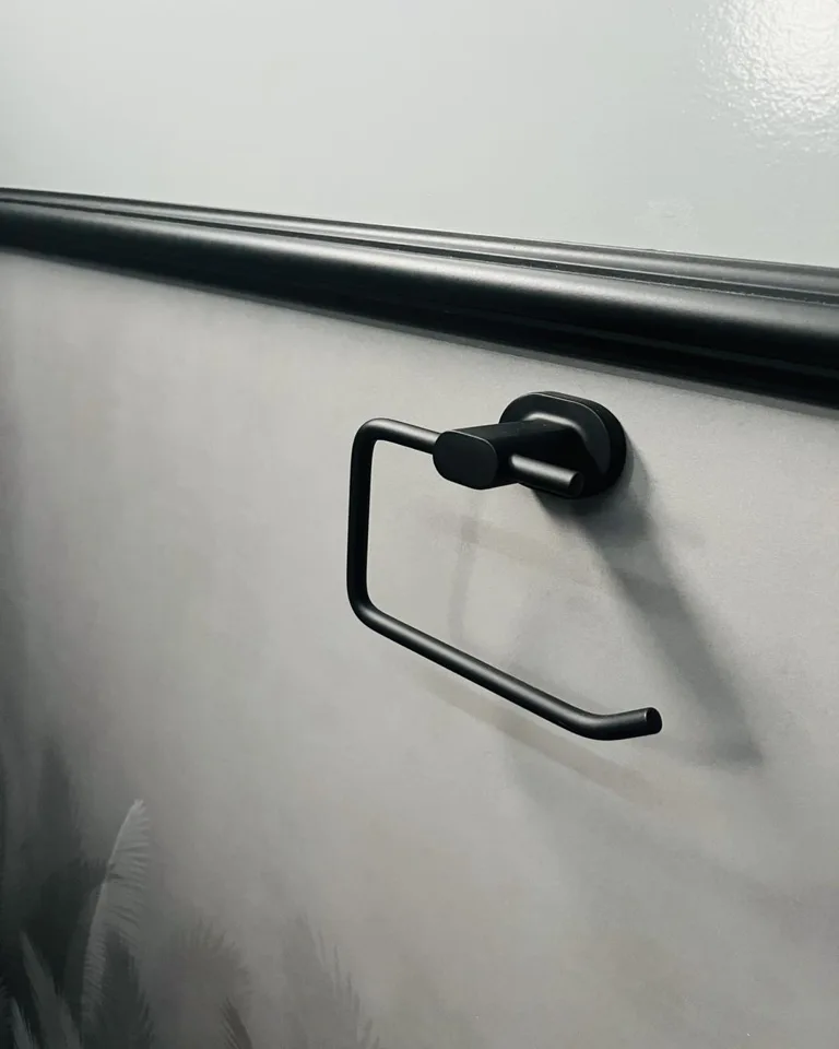 Toilet paper holder on a restroom trailer interior wall