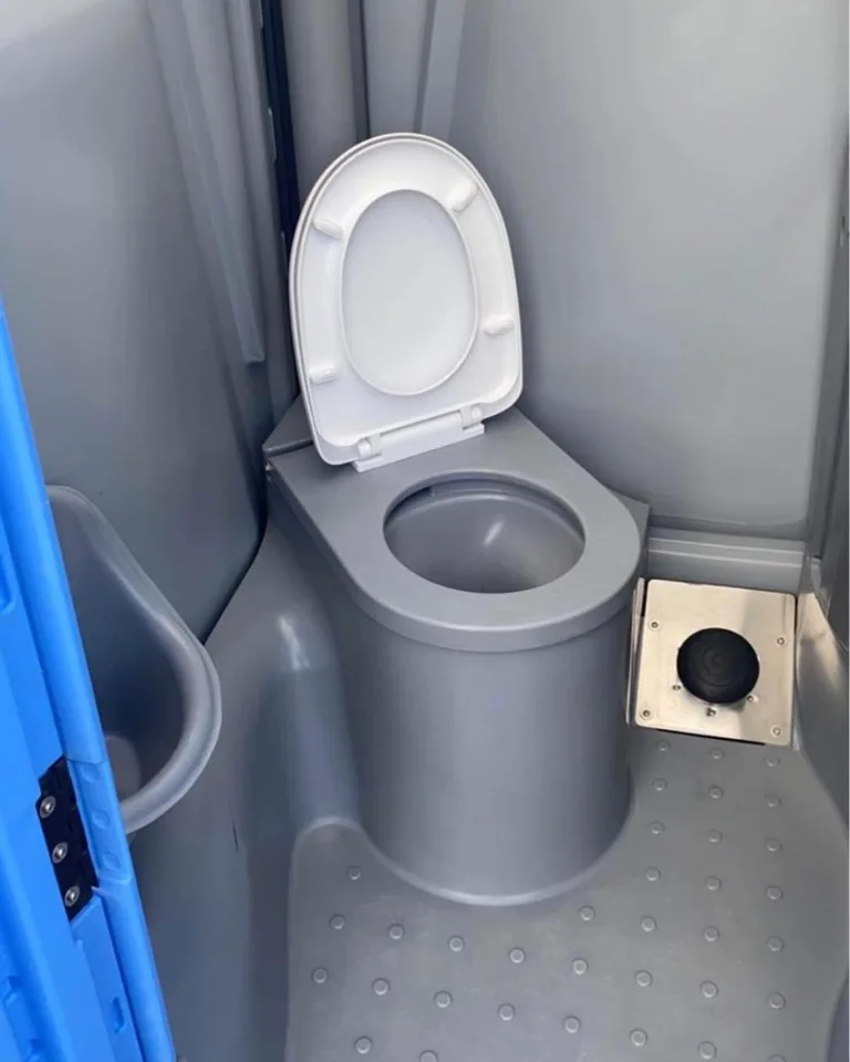 Close-up of a portable toilet seat and toilet paper roll