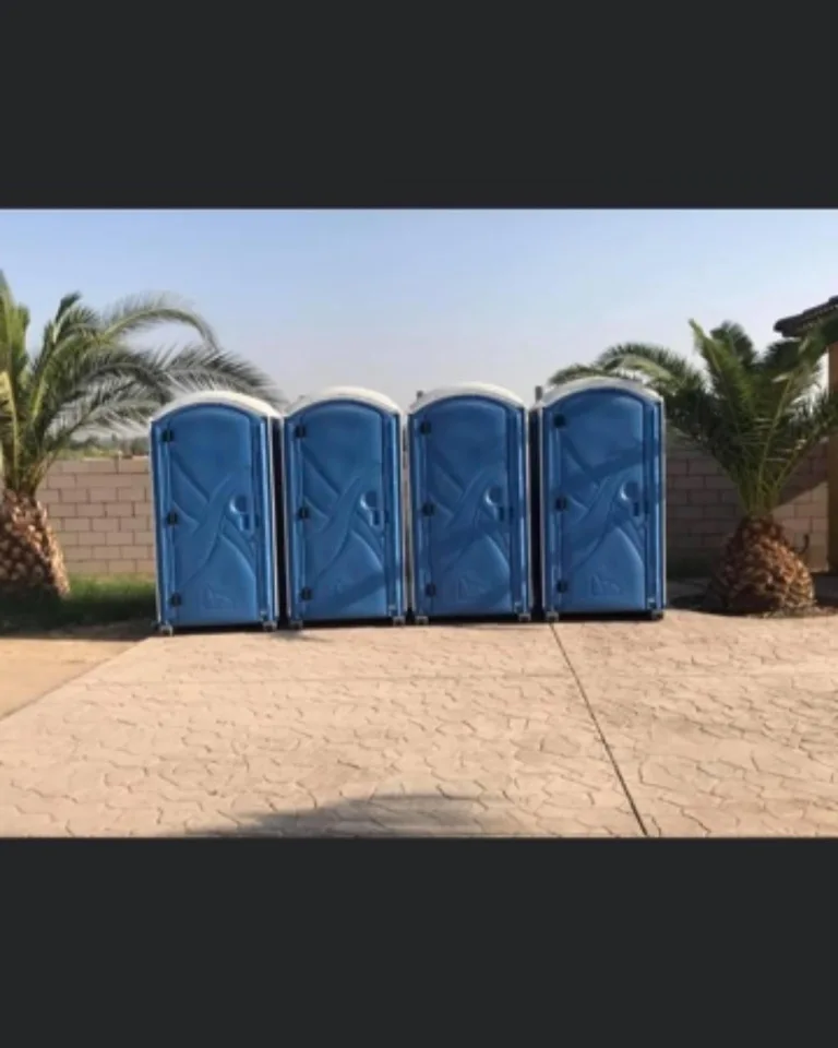 Row of blue portable toilets on an outdoor site
