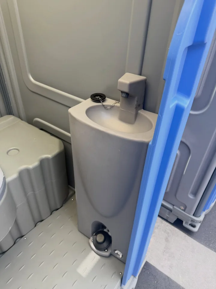 Compact handwashing sink inside a portable restroom
