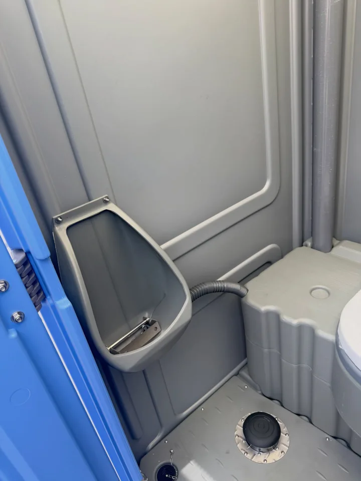 Overhead view of a portable toilet seat and adjacent urinal